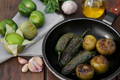 Photo of Different ingredients for cooking tasty salsa sauce on wooden table