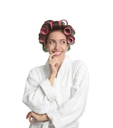 Beautiful young woman in bathrobe with hair curlers on white background