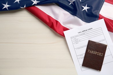 American flag, visa application form and passport on white wooden table, flat lay. Space for text