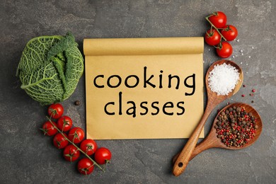 Paper with inscription Cooking Classes and different ingredients on black table, flat lay