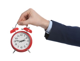 Businessman holding alarm clock on white background, closeup. Time management