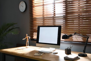 Modern computer and stationery on wooden table in office