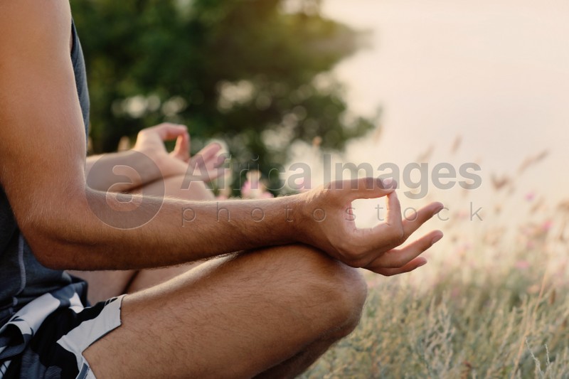 Man meditating outdoors on summer day, closeup