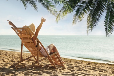Woman enjoying her summer vacation on sandy beach