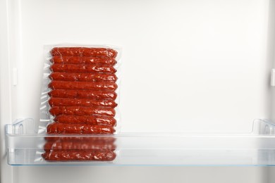 Photo of Vacuum bag with sausages in fridge, space for text. Food storage