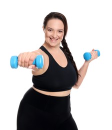 Happy overweight woman doing exercise with dumbbells on white background