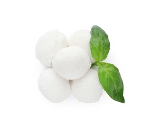 Delicious mozzarella cheese balls and basil on white background, top view