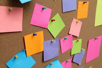 Many blank colorful notes pinned to corkboard
