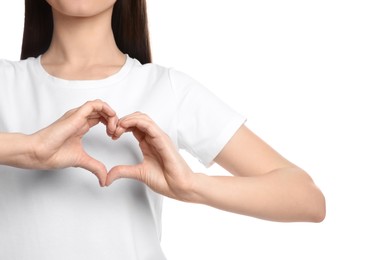 Woman showing heart on white background, closeup