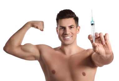 Athletic man with syringe on white background. Doping concept