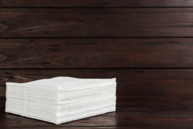 Clean napkins on wooden table, space for text