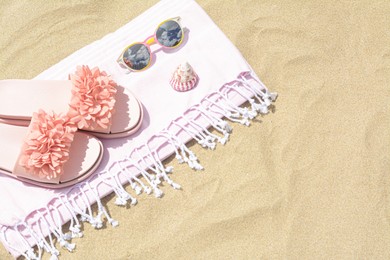 Photo of Stylish beach accessories on sand outdoors, above view. Space for text