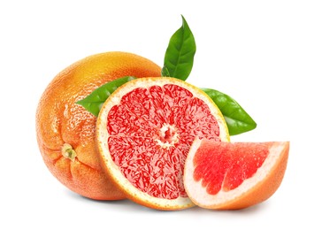 Tasty ripe grapefruits and green leaves on white background