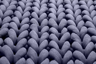 Closeup view of grey chunky knit blanket as background
