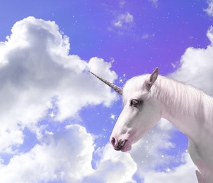 Magic unicorn in fantastic sky with fluffy clouds