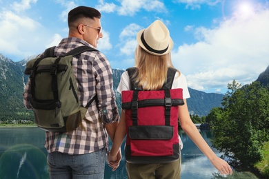 Image of Happy couple with travel backpacks enjoying their summer vacation trip