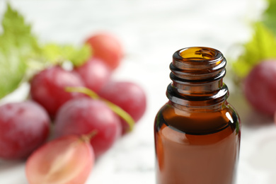 Bottle of natural grape seed oil, closeup with space for text. Organic cosmetic