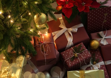Many different beautiful gifts under Christmas tree