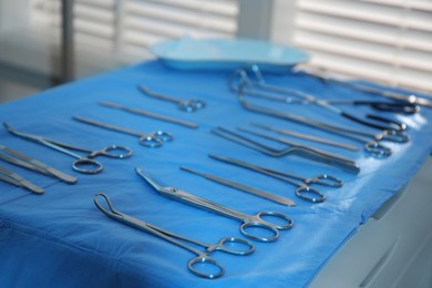 Different surgical instruments on blue table indoors