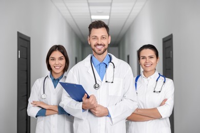 Photo of Team of professional doctors in clinic hallway