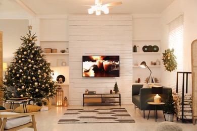 Photo of Plasma TV on white wooden wall in living room beautifully decorated for Christmas