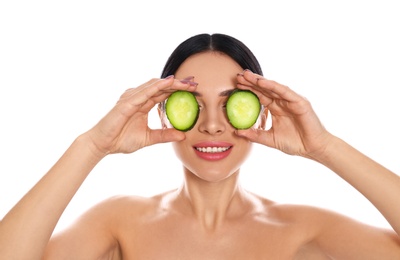 Photo of Young woman with silky skin after face mask holding cucumber on white background