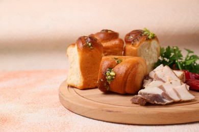 Photo of Delicious pampushky (buns with garlic), salo, peppers and parsley on color textured table, closeup. Space for text