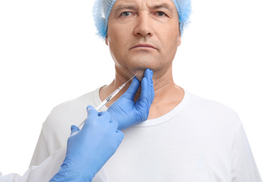 Mature man with double chin receiving injection on white background