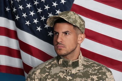 Soldier in uniform and United states of America flag on background