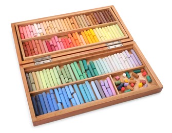 Set of soft pastels on white background in wooden box. Drawing material