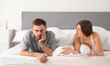 Young couple quarreling in bedroom. Relationship problems