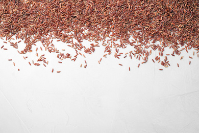 Brown rice on white background, top view