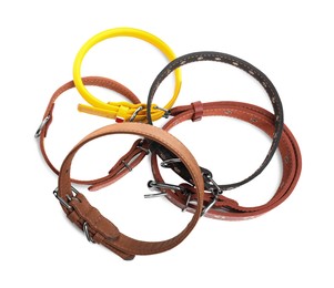 Different leather dog collars on white background, top view