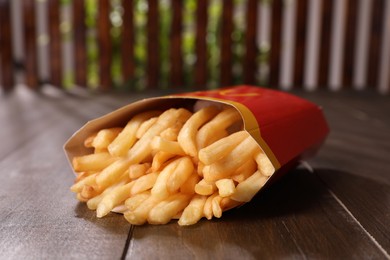 MYKOLAIV, UKRAINE - AUGUST 12, 2021: Big portion of McDonald's French fries on wooden table, closeup