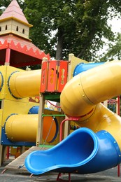 Photo of Children's playground with bright slide on summer day