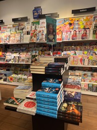 Photo of WARSAW, POLAND - JULY 23, 2022: Rack with different magazines and books in store