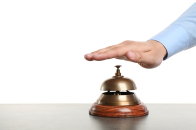 Man ringing hotel service bell at grey stone table
