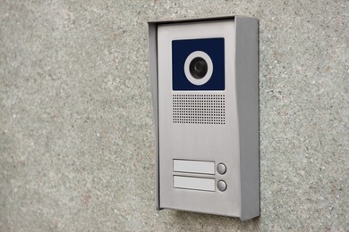 Photo of Home security system on light grey wall. Space for text