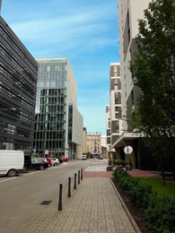 Photo of Beautiful view of modern buildings and car parking lots on city street