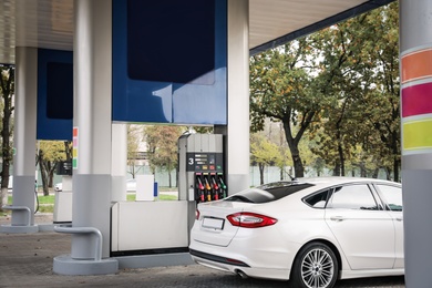 Photo of Car at modern gas station on sunny day outdoors