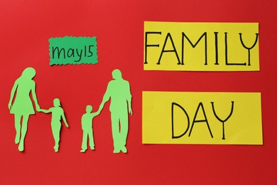 Family paper cutout and cards on red background, flat lay