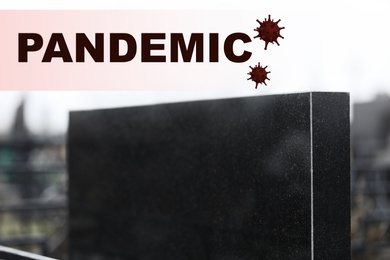 Black granite tombstone outdoors, closeup. Outbreak of pandemic disease