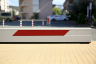 Photo of Closed boom barrier in city on sunny day, closeup