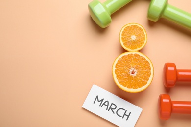 8 March greeting card design with cut citrus, dumbbells and space for text on orange background, flat lay. International Women's day