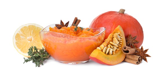 Photo of Glass bowl with pumpkin jam and ingredients on white background