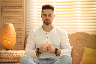 Young man during self-healing session in therapy room