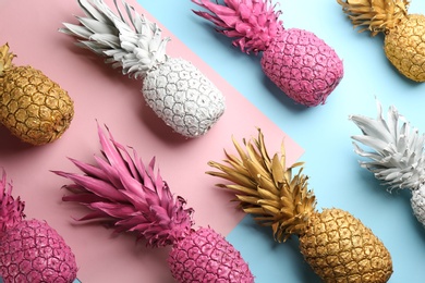 Many white, pink and golden pineapples on color background, flat lay. Creative concept
