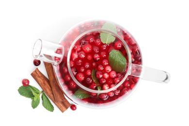 Tasty hot cranberry tea with mint and cinnamon in teapot on white background, top view