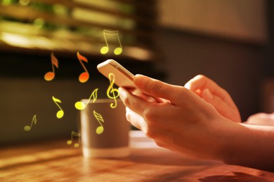 Image of Woman listening to music on mobile phone indoors, closeup. Music notes illustrations flowing from gadget
