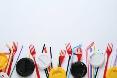 Plastic dishware on white background, flat lay. Space for text